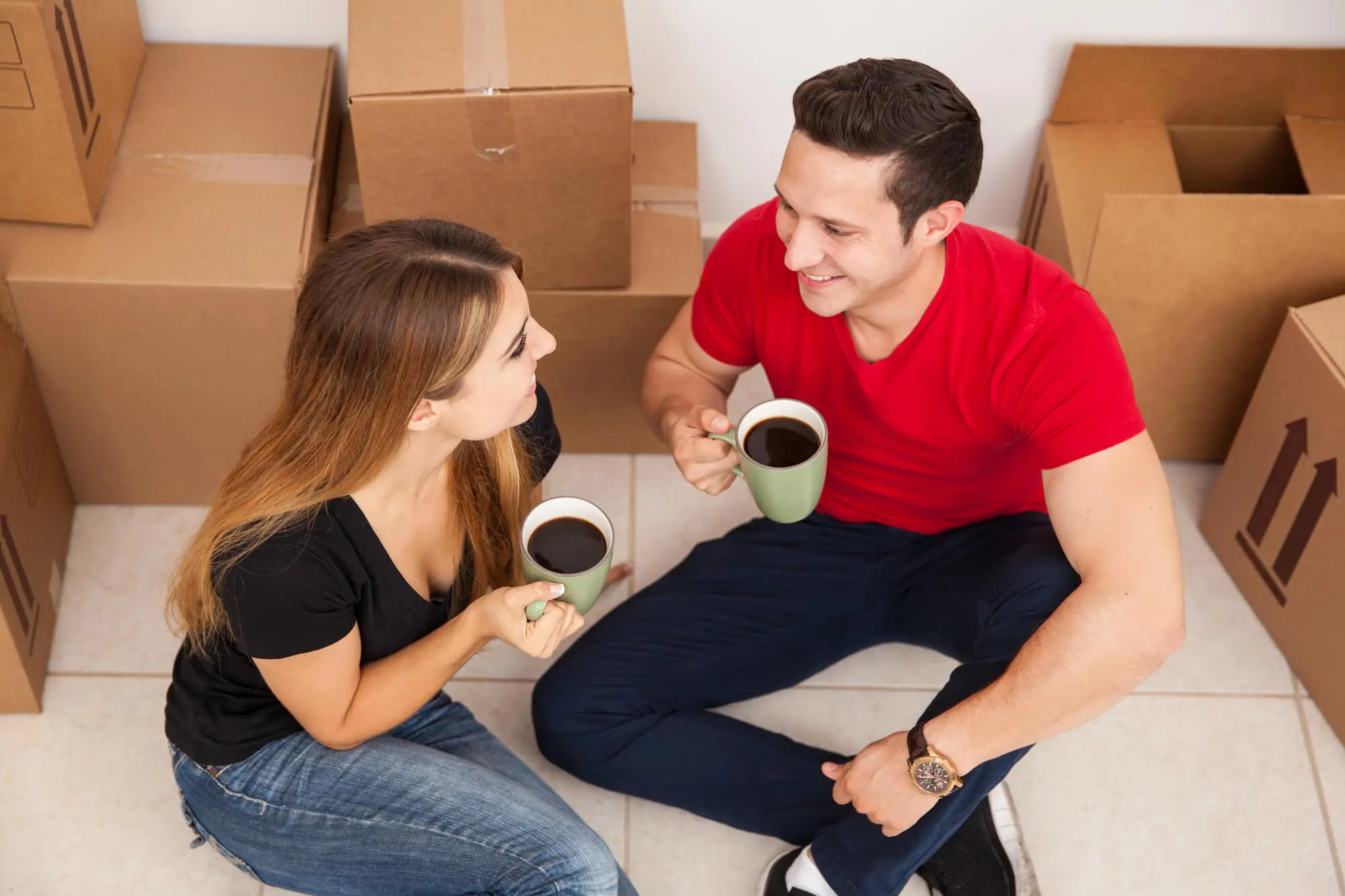 Happy-Couple-Using-Their-Mugs-After-Relocating-with-Moving-Companies-in-Lawrenceburg-Indiana