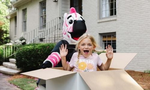 child enjoying moving day with pink zebra mascot wilmington nc