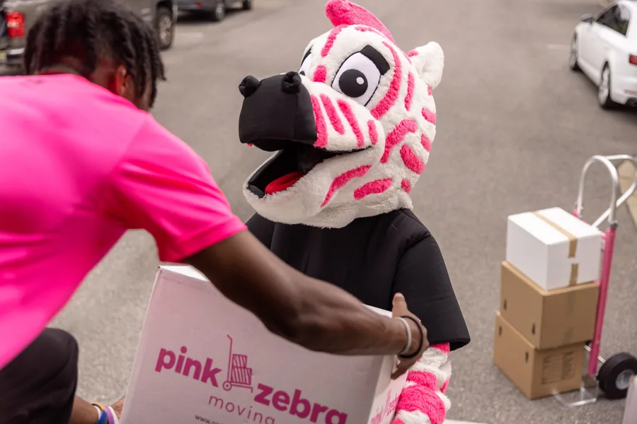 friendly chesterfield mo movers unloading boxes with mascot