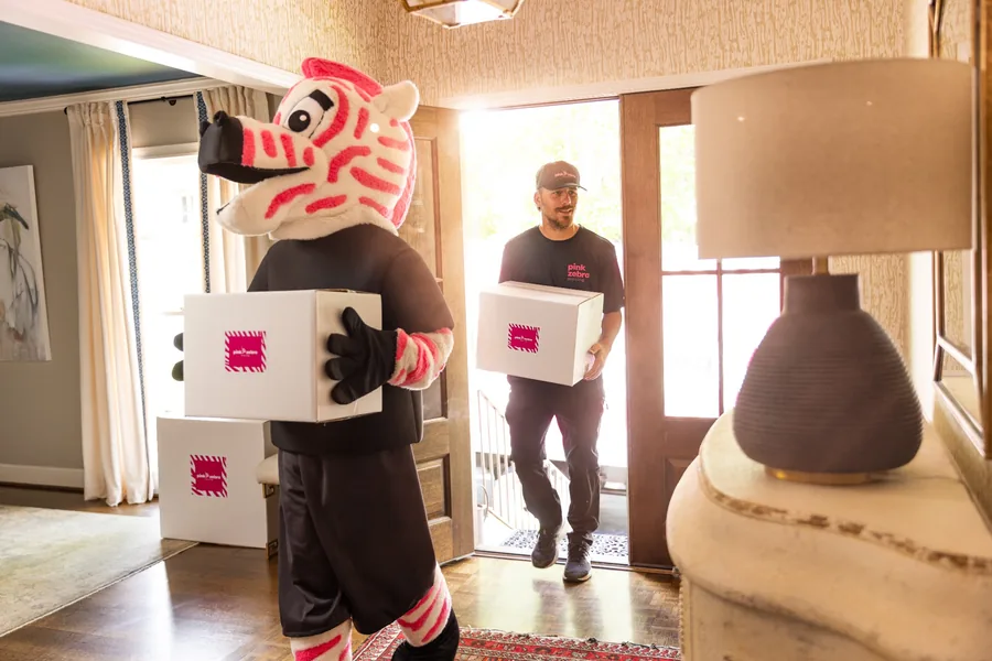 pink zebra moving team delivering boxes to a home in katy tx