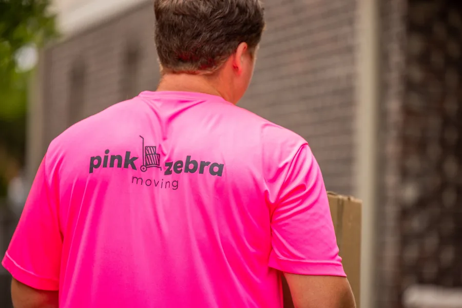 pink zebra moving team member carrying boxes during a residential move in lake norman nc